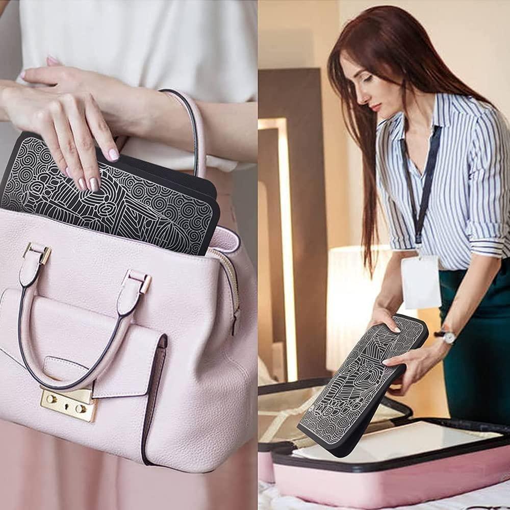 The Gir Farmer EMS foot massager pad with black patterned design being placed in a pink handbag and held by a woman