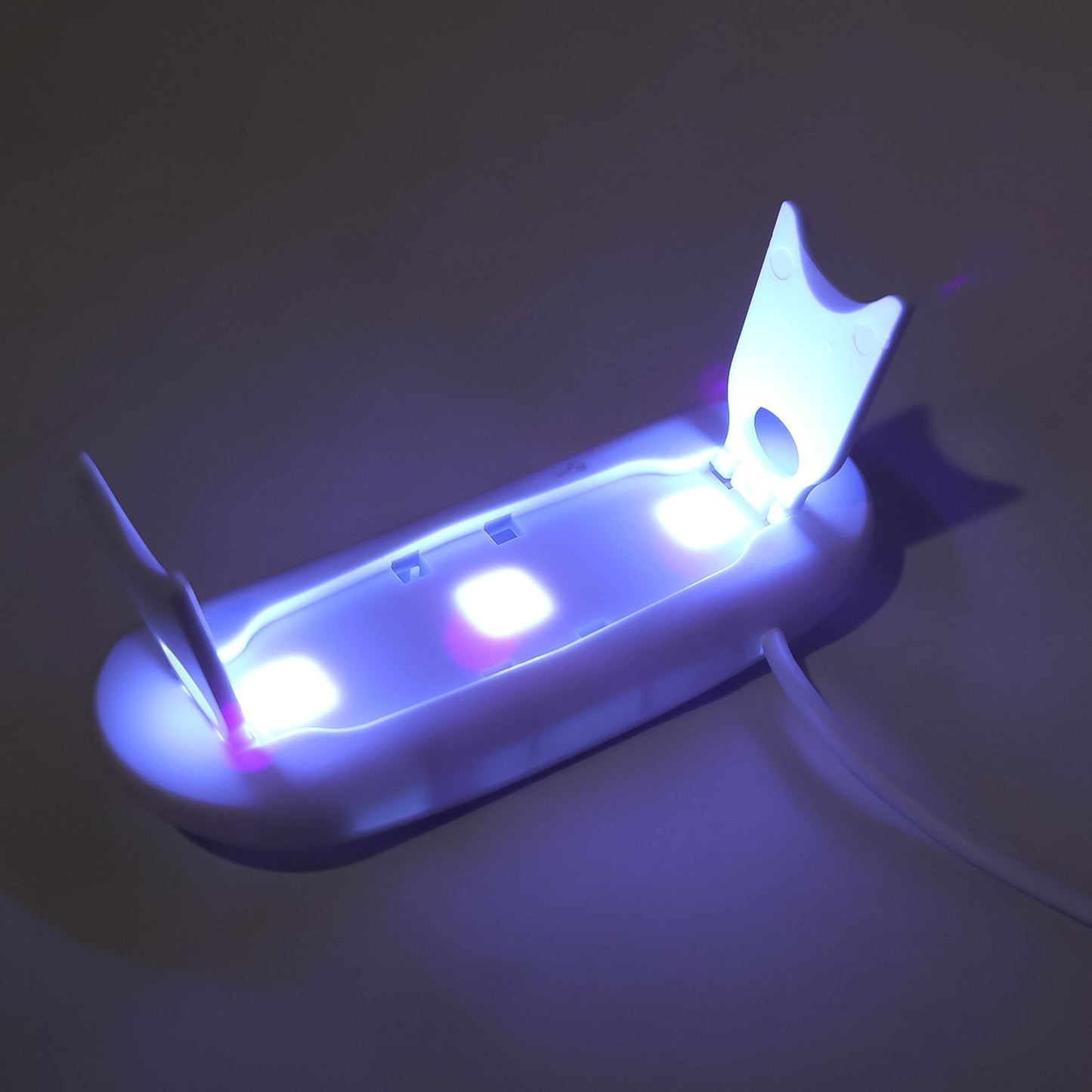 Compact mini UV nail lamp for gel polish with dual light source for efficient curing.