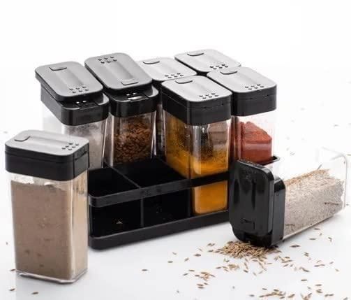 Airtight spice jar set with black lids and a black tray holding six clear jars filled with various spices