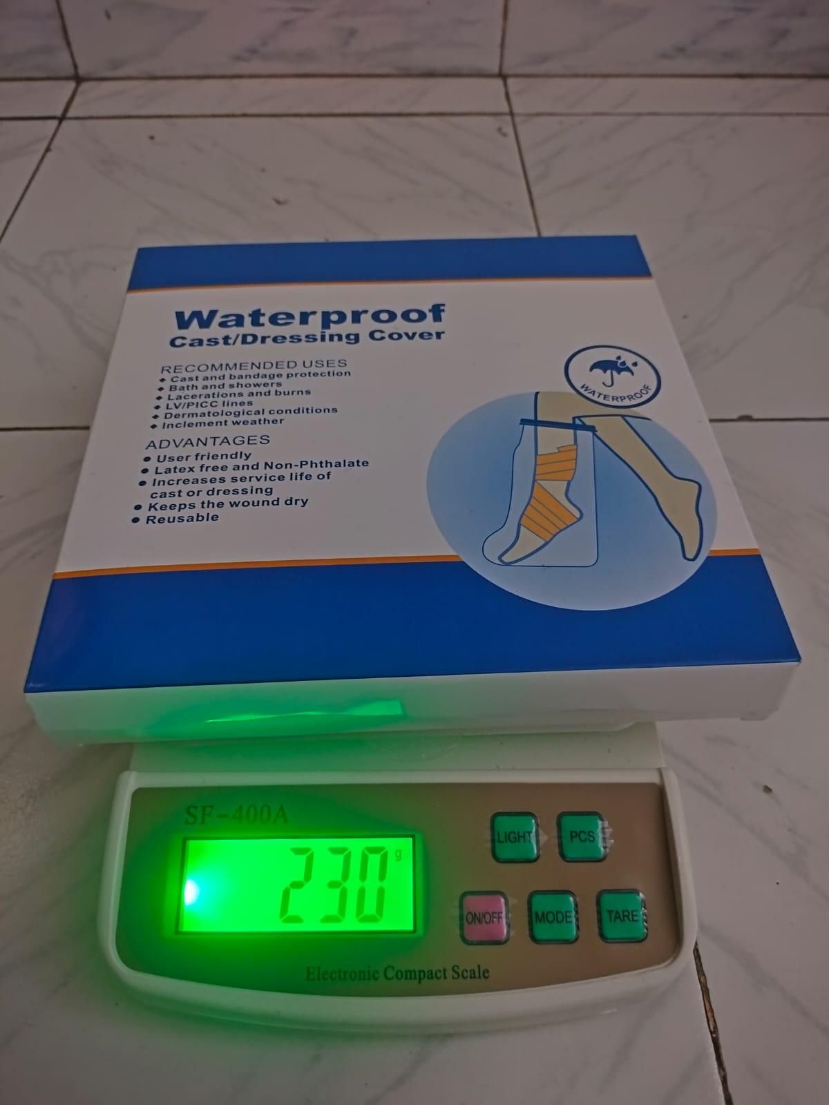 THE GIR FARMER waterproof cast dressing box on digital scale showing 230g reusable cast cover for leg injury