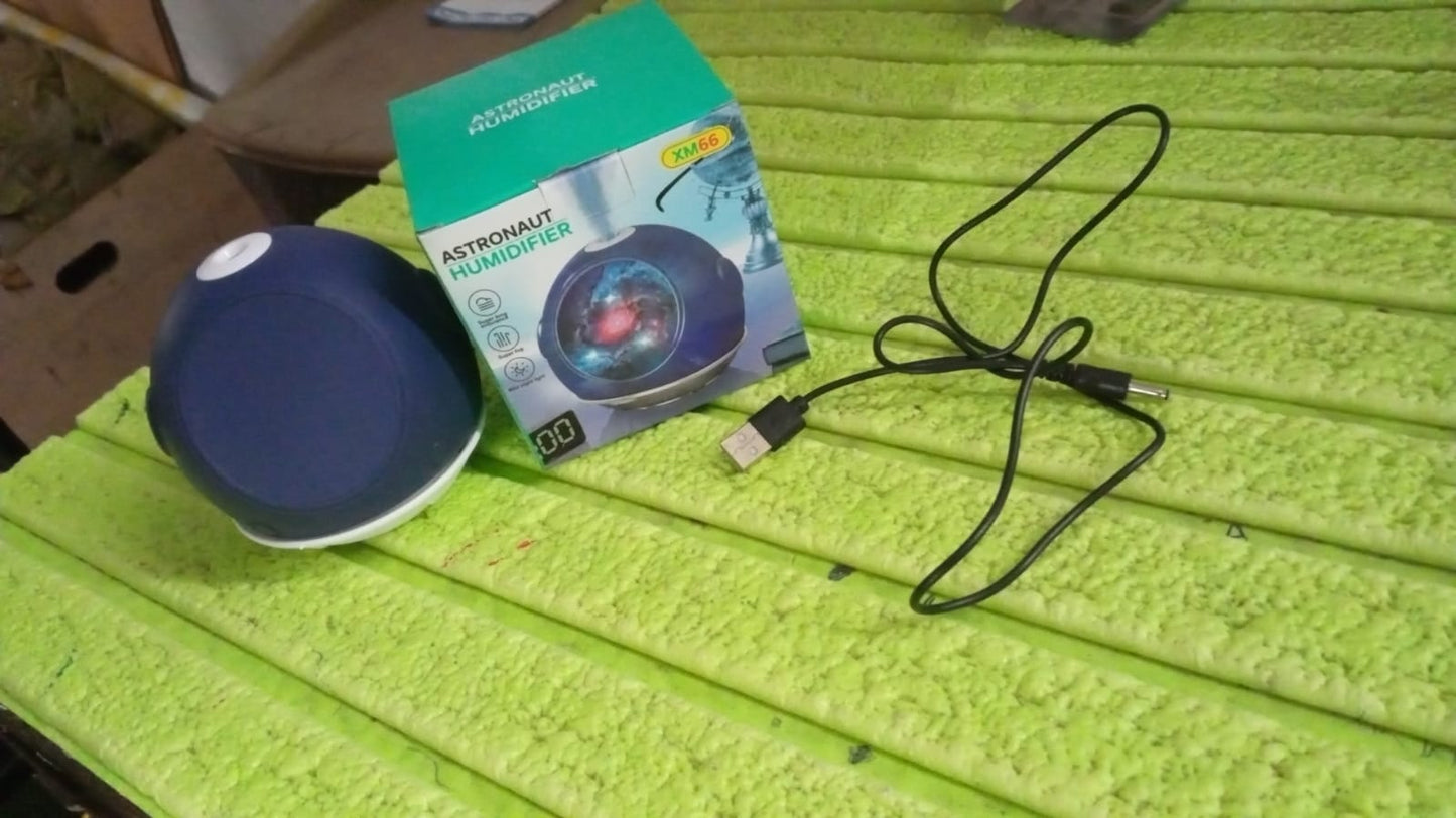 Your Brand astronaut humidifier for home in blue with box and USB cable on a bright green surface