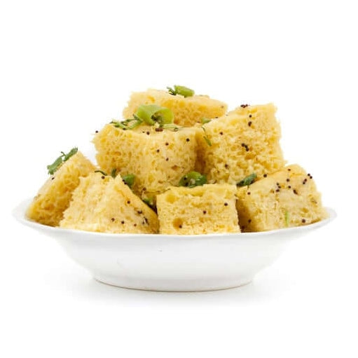 Delicious dhokla pieces made from authentic Gujarati dhokla flour served on a white plate