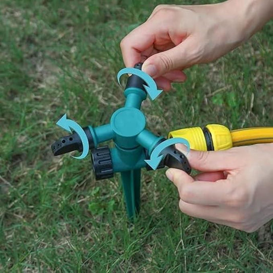 THE GIR FARMER automatic rotating yard sprinkler with hands adjusting water flow on green grass