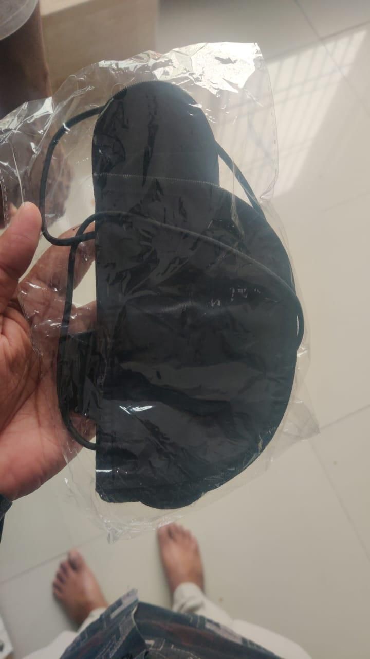 Black travel eye mask with elastic band in plastic packaging not an adjustable luggage strap