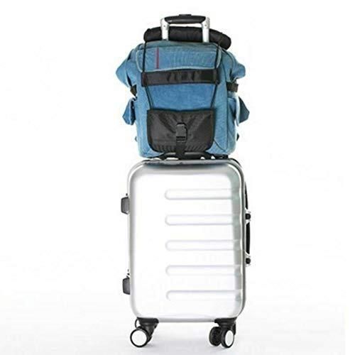 Blue backpack secured to a silver rolling suitcase handle with adjustable luggage strap for travel