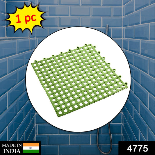 Green bath anti slip mat designed for safety in wet areas, featuring a perforated surface