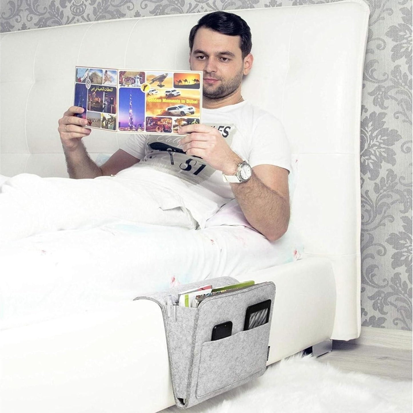 THE GIR FARMER bedside pocket organizer for essentials attached to white bed holding phone and magazines