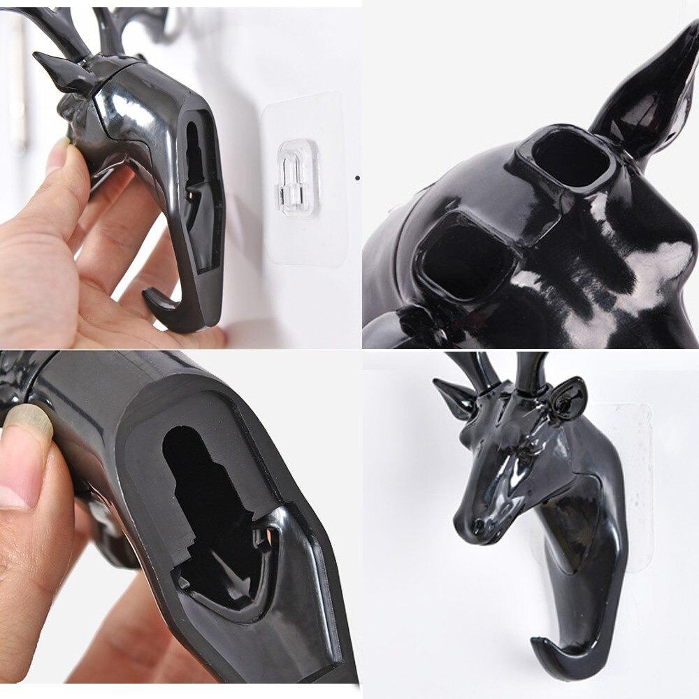 Black deer head self adhesive coat hook mounted on white wall for hanging items