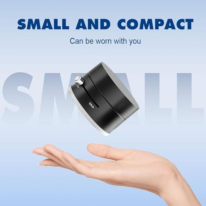 Small and compact magnetic car dashboard phone holder held above an open palm against a blue background