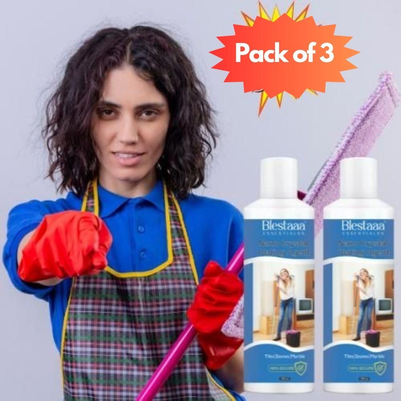 Pack of 3 Blesta organic fabric stain remover bottles with woman cleaning wearing red gloves and plaid apron