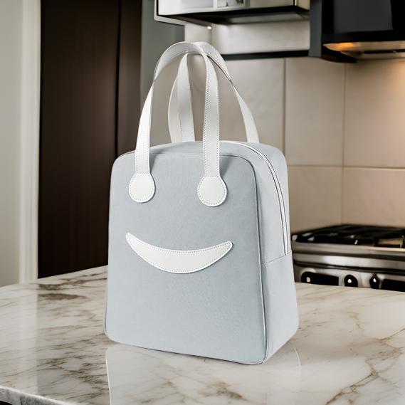 THE GIR FARMER large insulated lunch bag in light gray with white handles on marble kitchen countertop