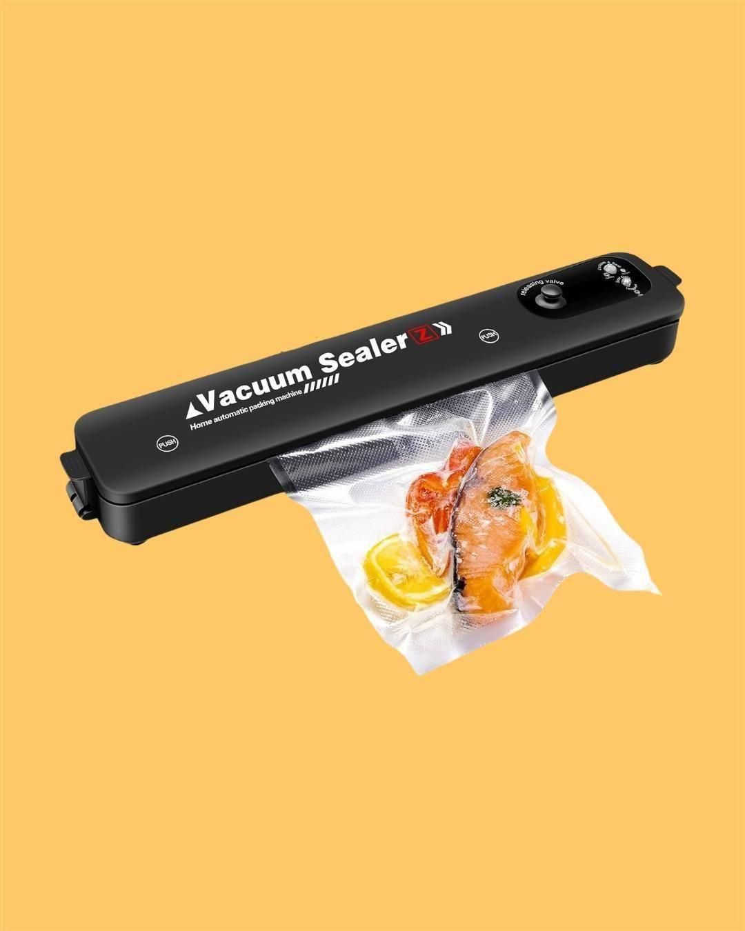 THE GIR FARMER multi-functional vacuum sealing machine in black sealing a bag with salmon and lemon