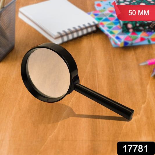 Breakage-proof magnifying glass for reading on a wooden desk with office supplies