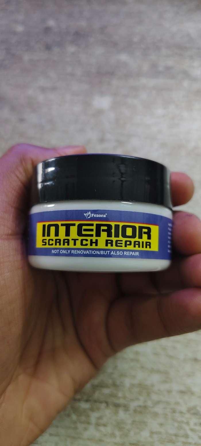 8feb97-4 car interior scratch repair cream in a hand for fixing vehicle surface scratches