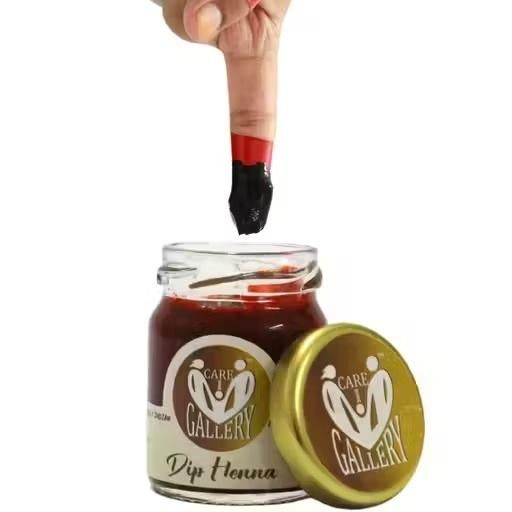 Care Gallery Instant Red Henna Mehendi Paste in a jar with a finger demonstrating application technique