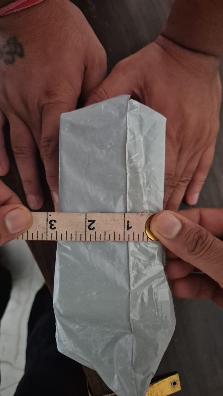 Hands measuring wrapped aquarium water cleaner for freshwater and saltwater with a ruler