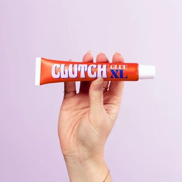 The Gir Farmer Clutch Glue XL tube held in hand for sensitive skin body glue application