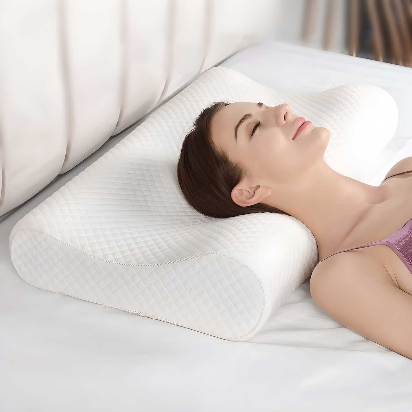 Woman resting on a white contour pillow for neck pain with ergonomic support on bed