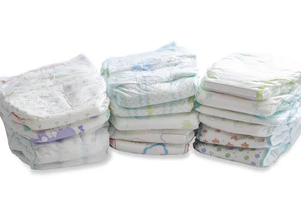 Stack of cotton soft diapers for infants in various designs and sizes, ideal for comfortable and gentle use