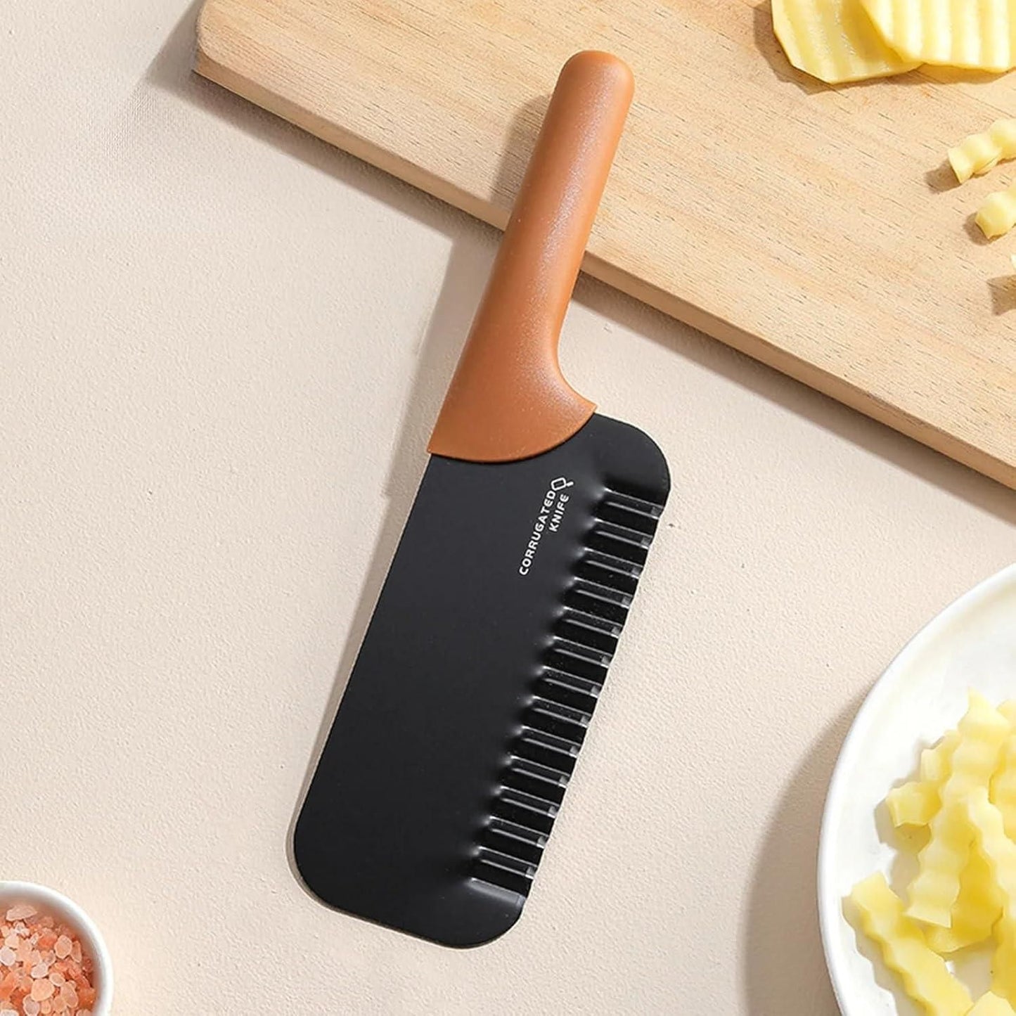 THE GIR FARMER crinkled chopper kitchen tool with brown handle and black blade on countertop