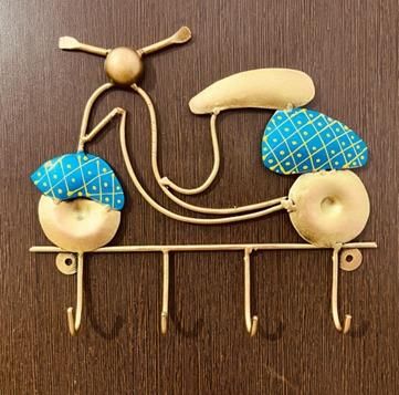 Decorative wall key holder shaped like a scooter with blue and gold accents by THE GIR FARMER