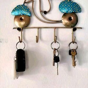 THE GIR FARMER decorative wall key holder with metal hooks and blue mushroom accents holding keys