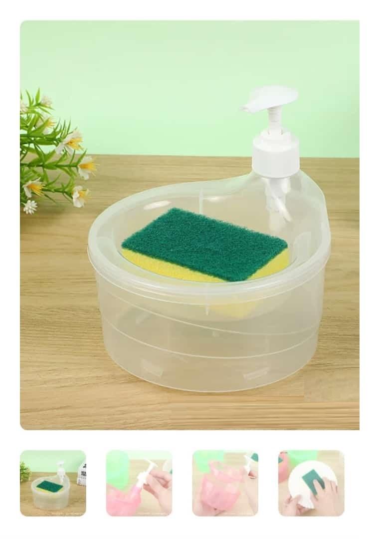 Clear plastic liquid soap dispenser for dishwashing with built-in sponge holder on wooden surface