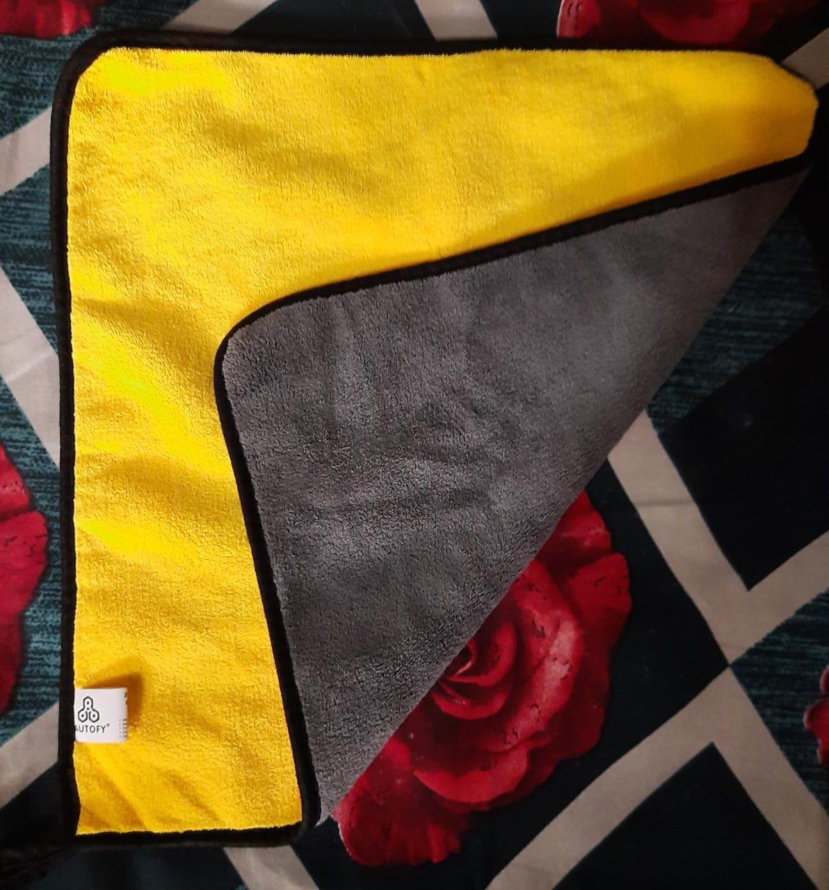 Double sided automotive cleaning towels in yellow and gray for effective car cleaning and detailing