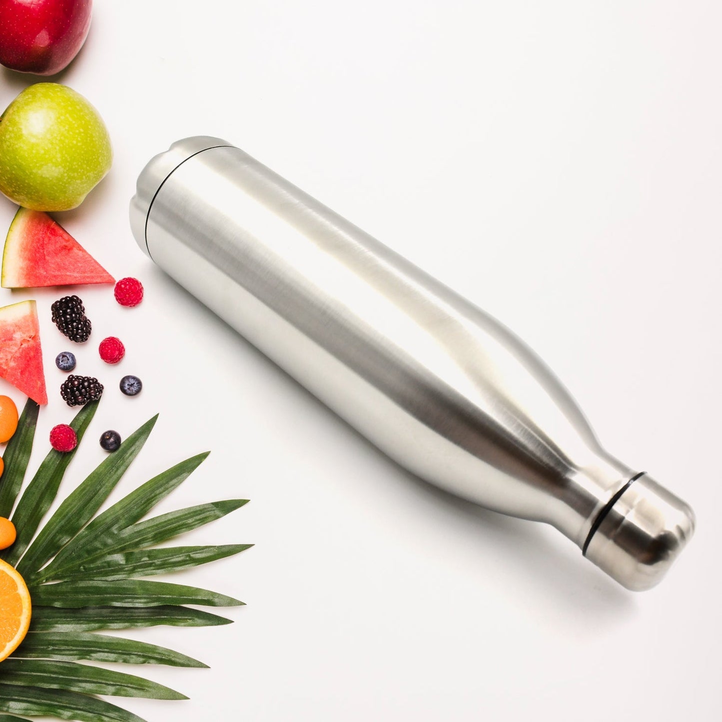 sleek stainless steel double wall thermos bottle for travel surrounded by fresh fruits