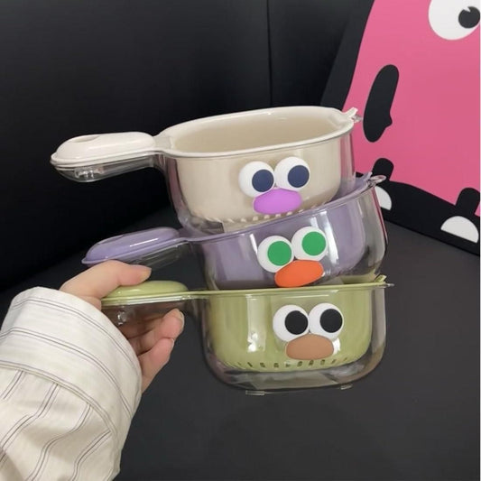 THE GIR FARMER dual layer fruit and veggie strainer set with colorful faces and handles held in hand