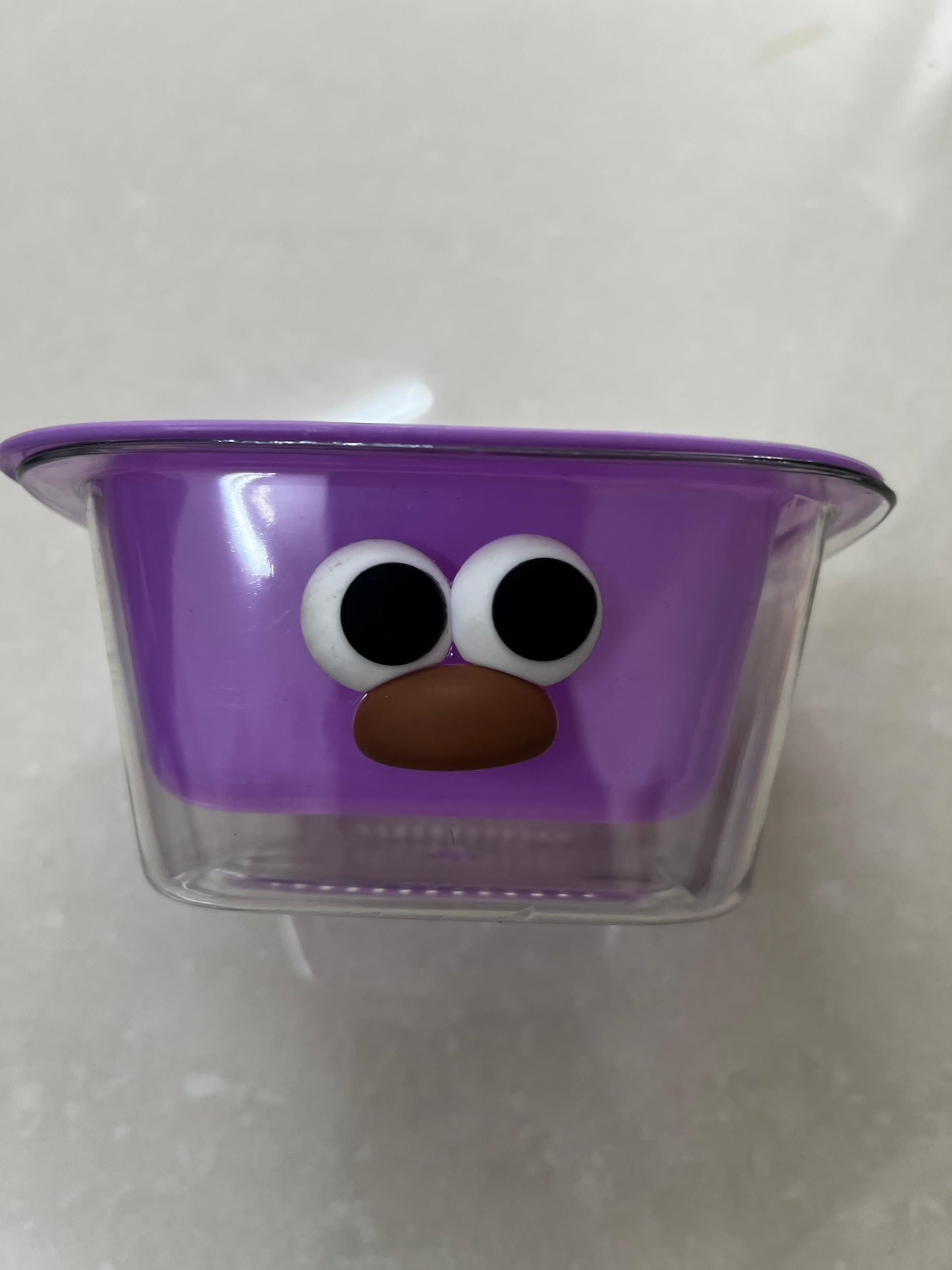 THE GIR FARMER dual layer fruit and veggie strainer in purple with a playful face design