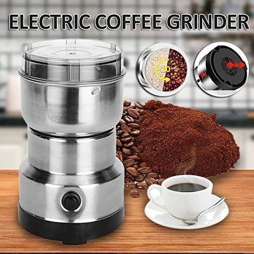 Electric portable coffee bean grinder in stainless steel with ground coffee and cup of coffee