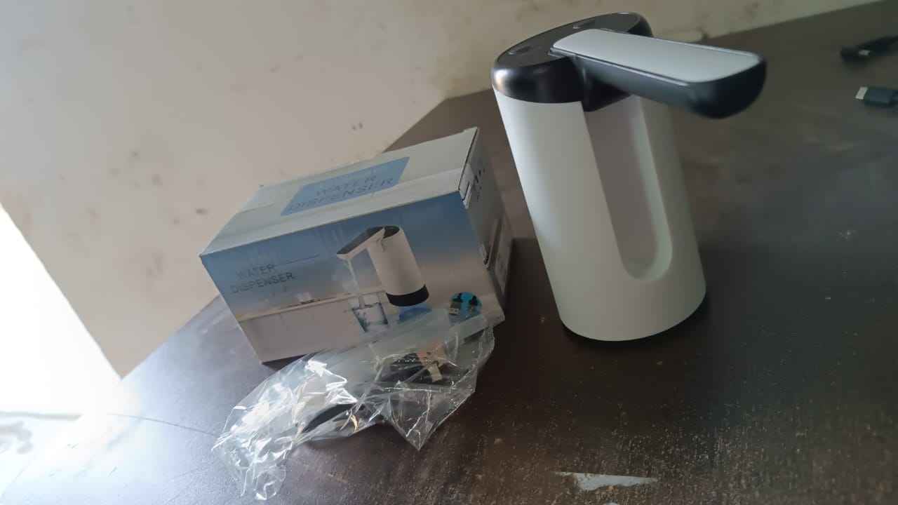Wukusy electric water dispenser pump with sleek design and box on a wooden table