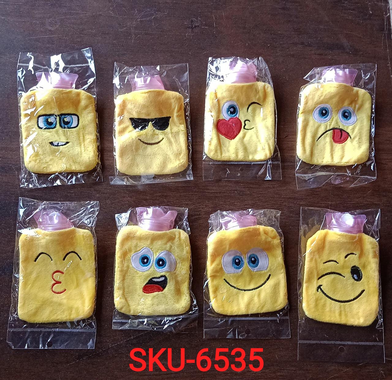 Set of emoji mini hot water bag with various playful expressions for cozy comfort