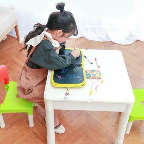 Child drawing on an erasable doodle slate for kids at a white table with colorful markers