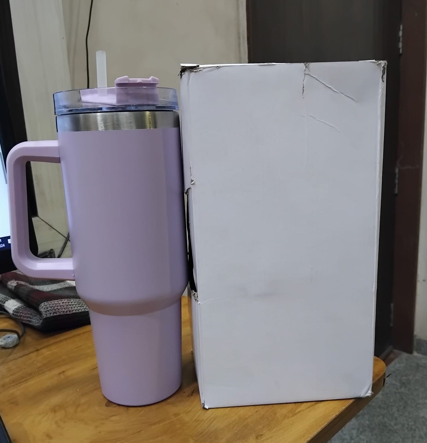 The Gir Farmer lavender insulated sipper bottle with straw and handle stainless steel rim next to white box