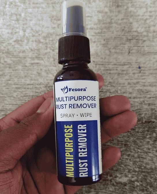 Fezora multipurpose rust remover spray bottle labeled as best rust remover for home use held in hand