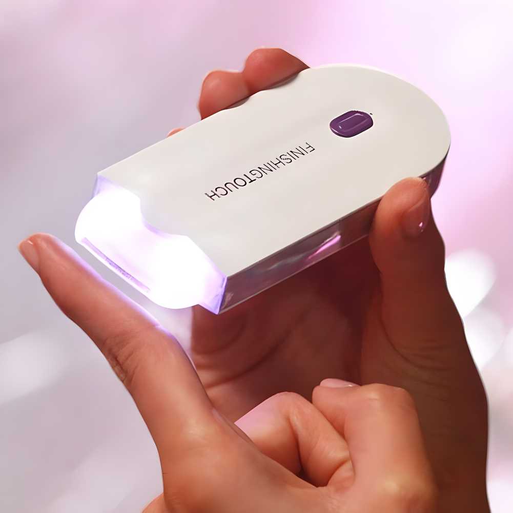 White FINISHNTOUCH device held in hand with light on showing painless facial hair remover