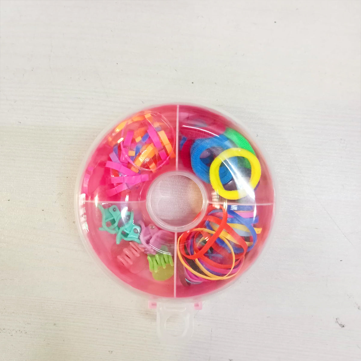 Amd-Deodap cute round hair accessories for girls organized in a pink circular plastic case