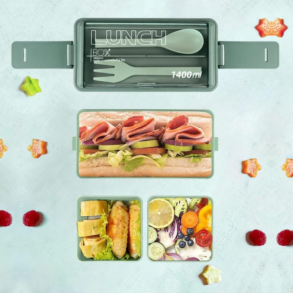 Green bento compartment lunch box with utensils, sandwich, chicken, and fresh fruit sections