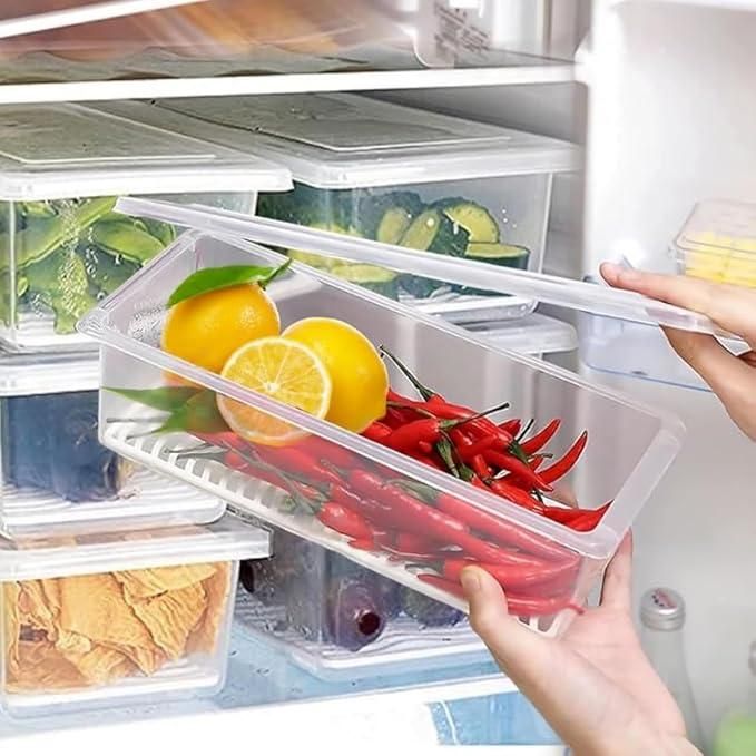 The Gir Farmer fridge storage containers set with clear airtight lids storing lemons and red chili peppers in a refrigerator