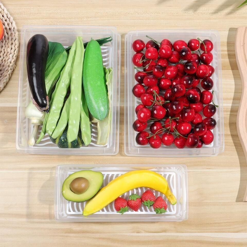 The Gir Farmer fridge storage containers set with fresh vegetables cherries and fruit on wooden surface