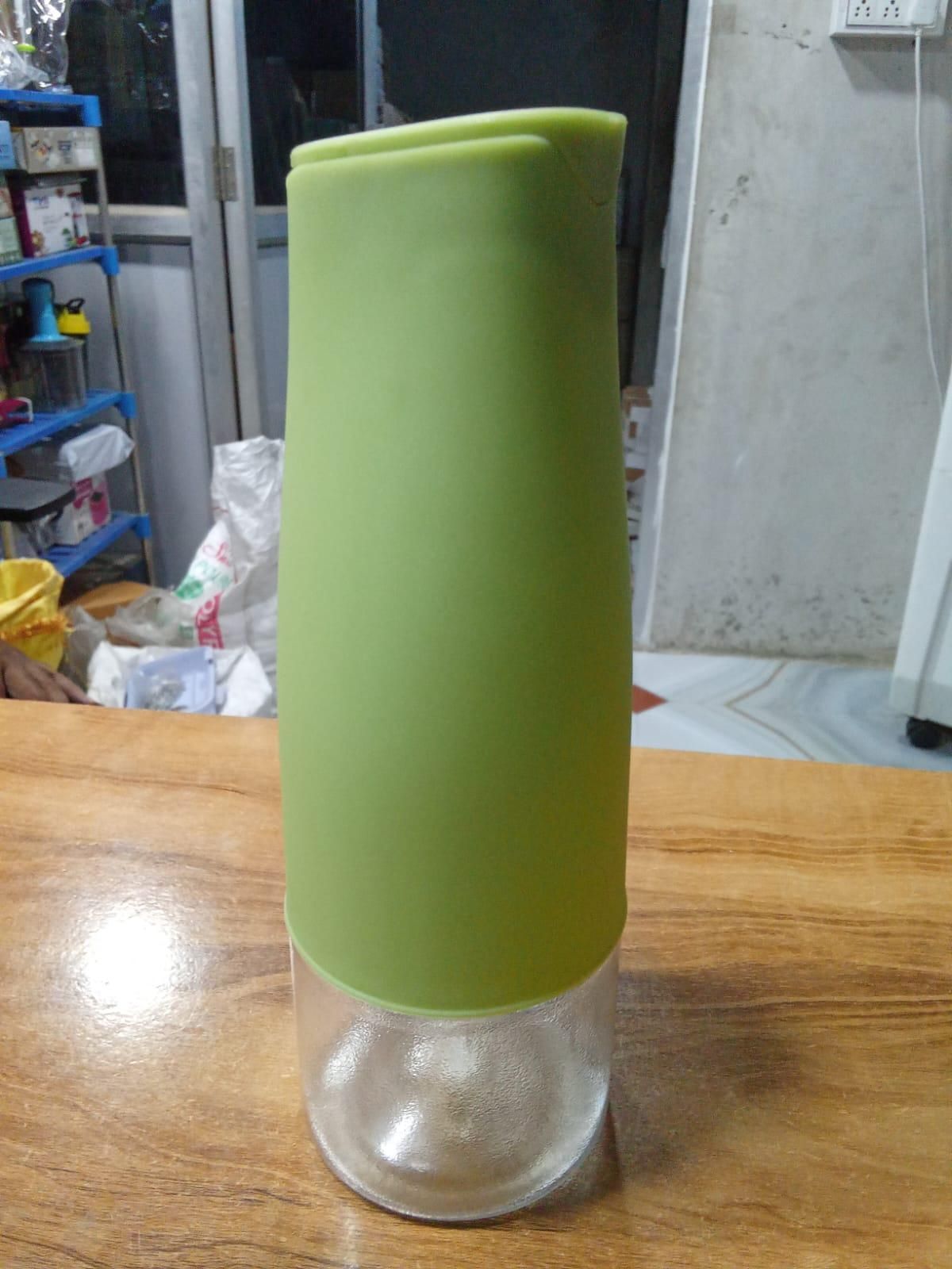 Green silicone top oil dispenser bottle for kitchen with clear glass base and ergonomic pour spout