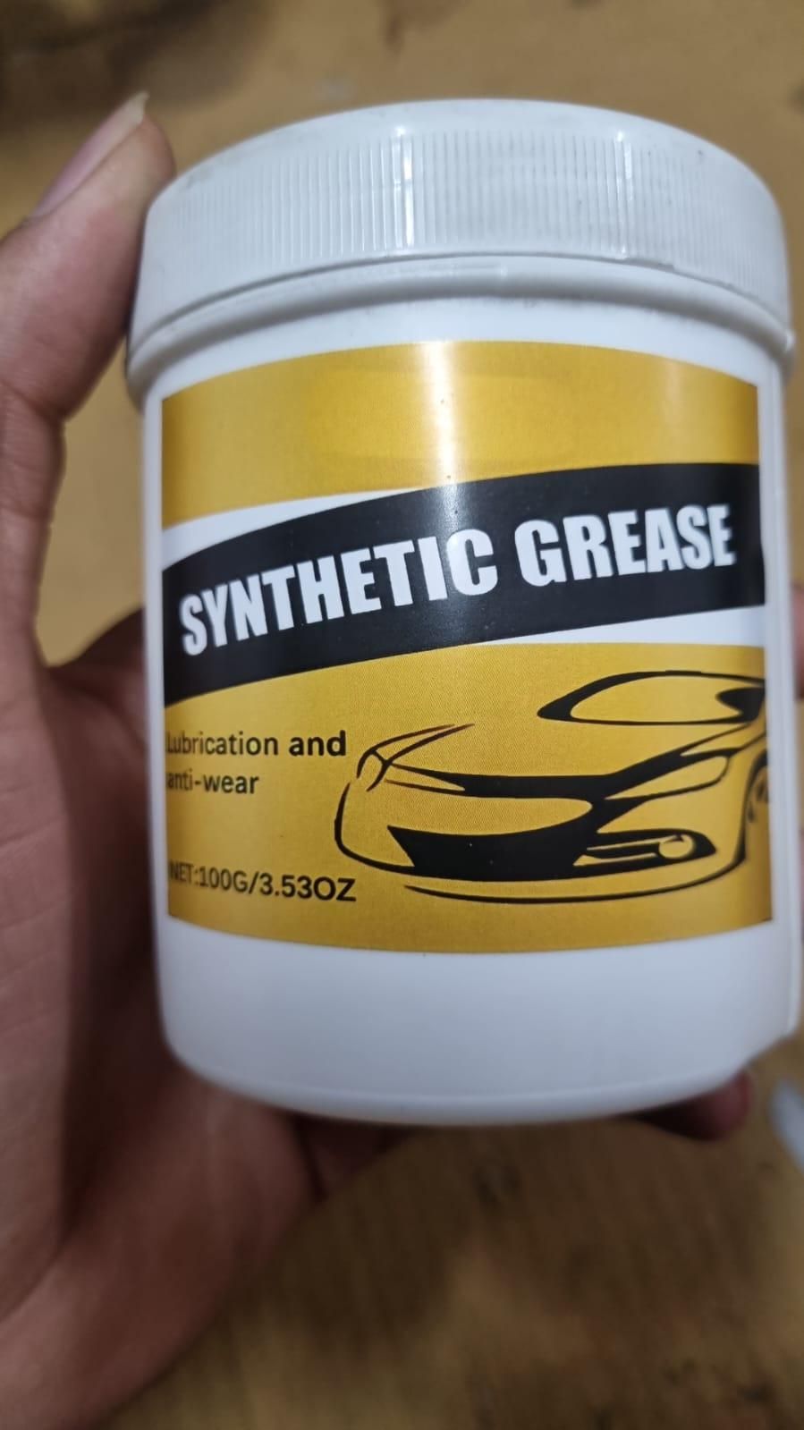 White container of synthetic car grease pack with yellow label showing car illustration and product details
