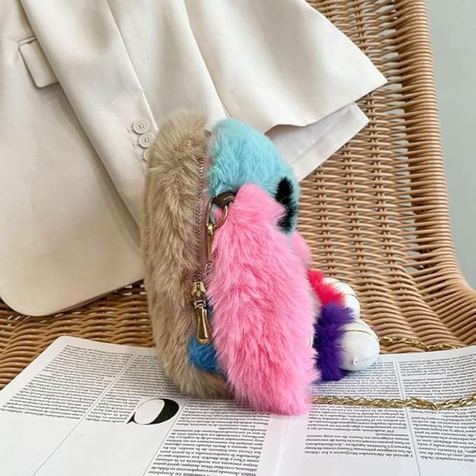 Girls bunny shaped sling bag with chain in colorful fluffy design displayed on wicker chair