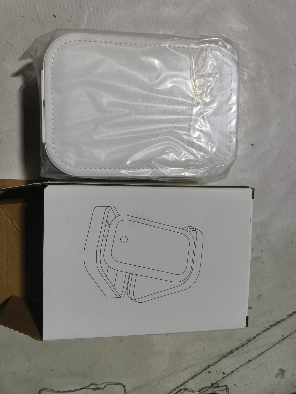 Small white rectangular device wrapped in plastic shown next to its white box with a line art illustration