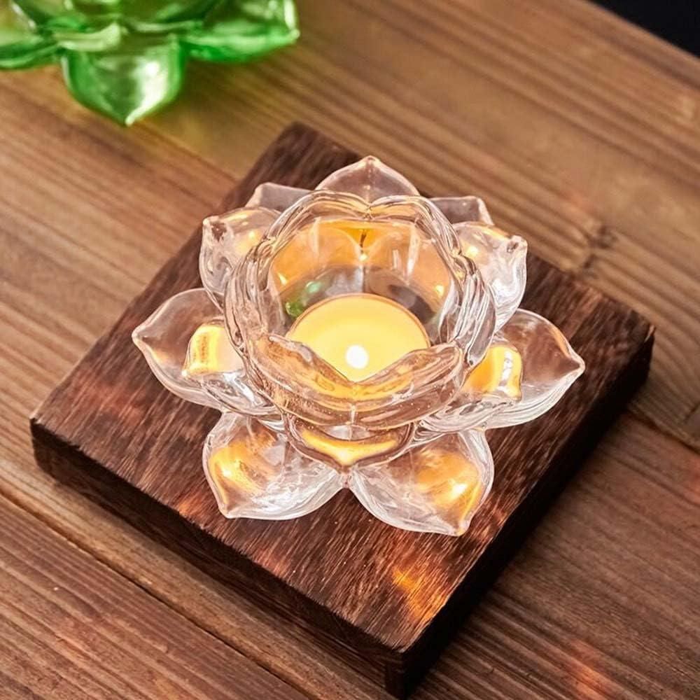Glass lotus tea light holder on wooden base with lit candle for decorative ambiance