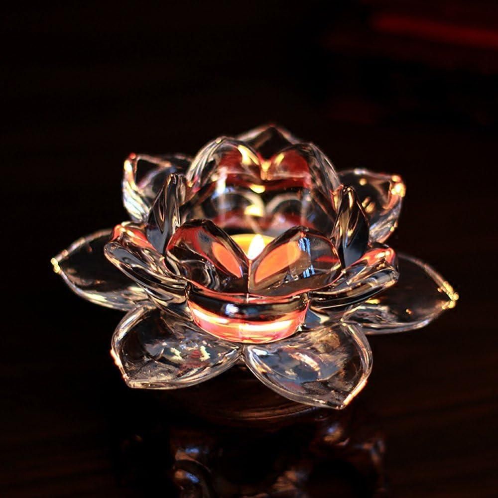 Elegant glass lotus tea light holder by THE GIR FARMER with a lit candle inside on a dark surface