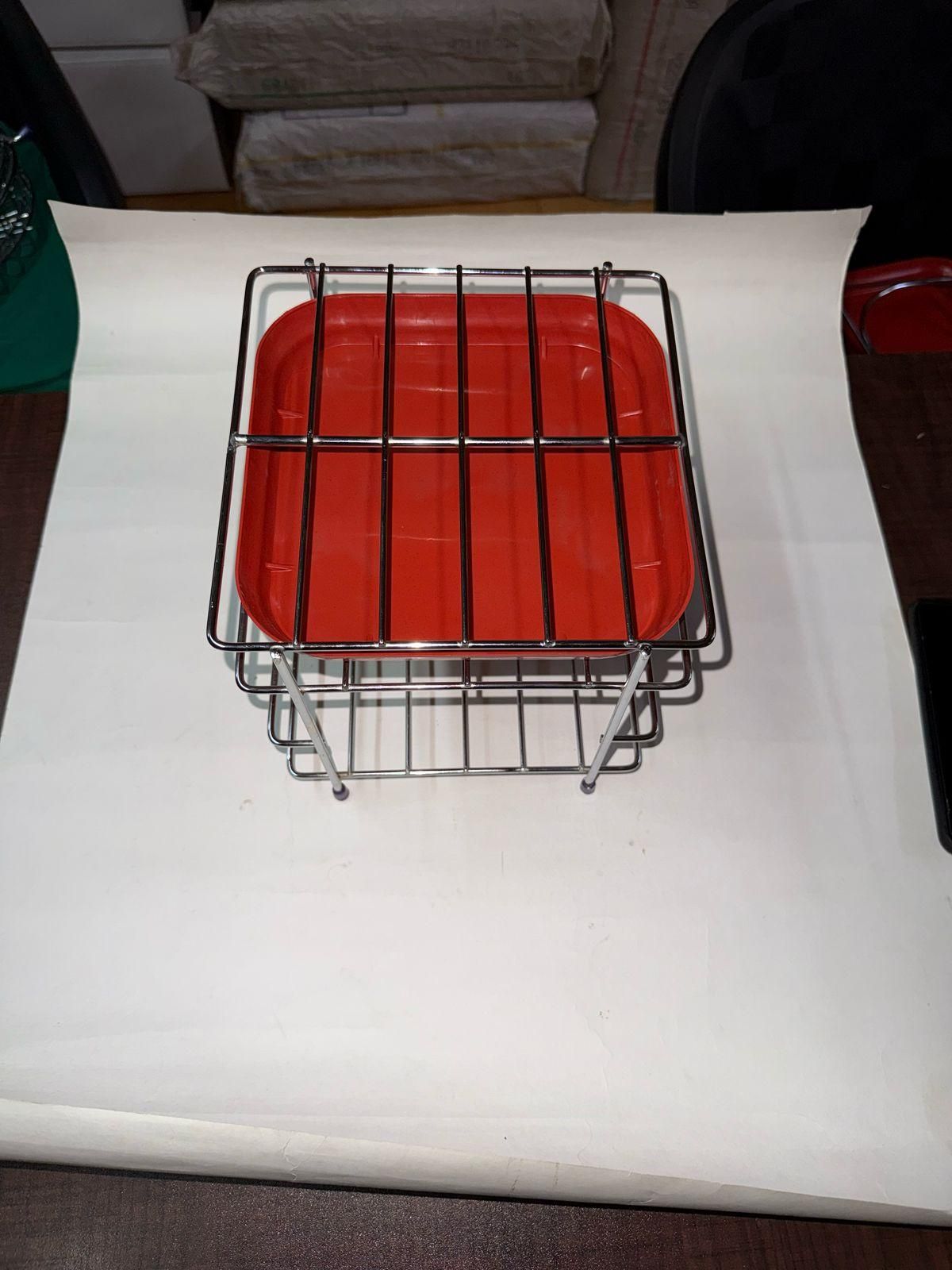 Heavy steel matka stand with a red tray, sturdy design for holding pots or containers