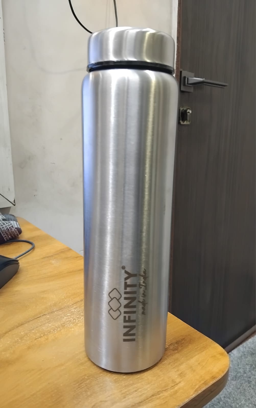 Infinity Artic Bottle stainless steel water bottle 1000ml with silver finish on wooden table